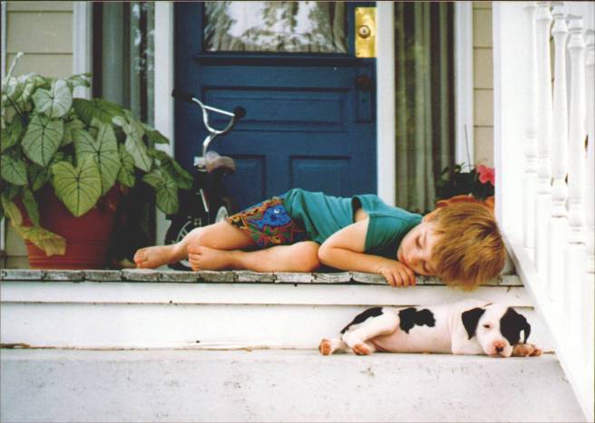 Submitted by Luanne:  "Chris Belew, my son, and the neighbor’s new puppy resting on our porch after playing."